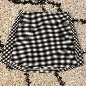 Size: Medium checkers type short skirt. Color: Black and white. FITS AS SMALL